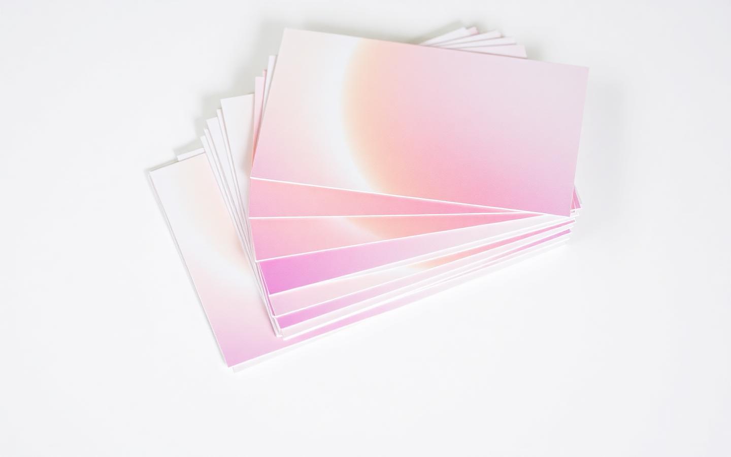 Printed postcards stacked on a clean surface