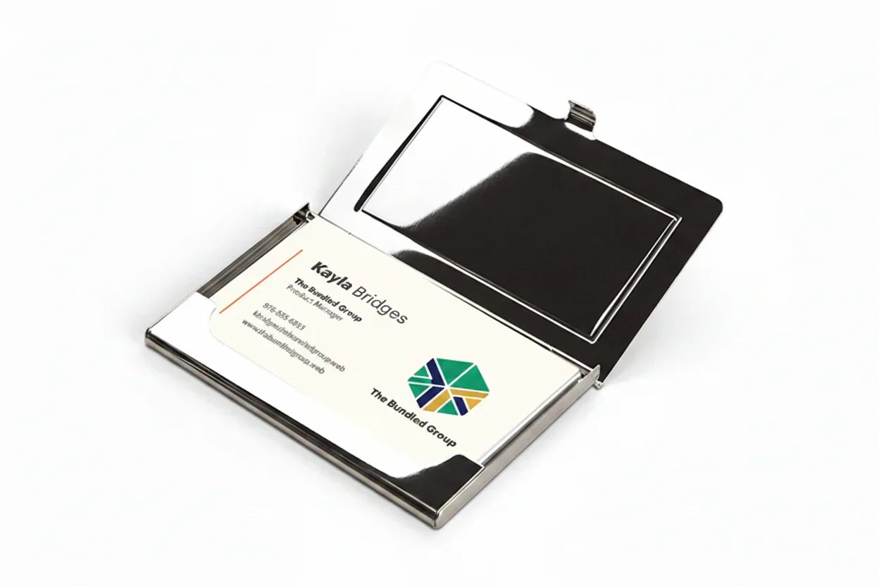 Sleek metal business card holder open with business cards inside on a white background.