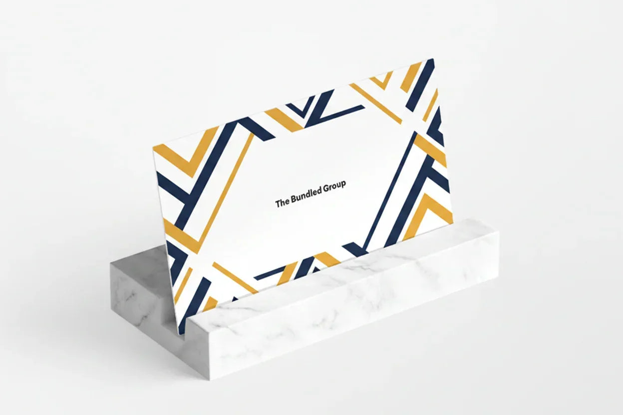 Colorful geometric patterned card on a white stand against a red background