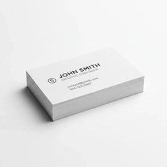 Stack of custom printed business cards on a white background, minimal design.