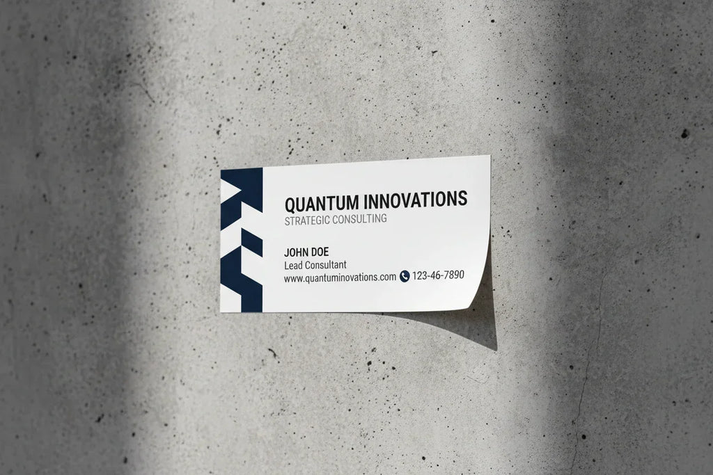 Custom business card sticker with company details adhered to a grey textured wall