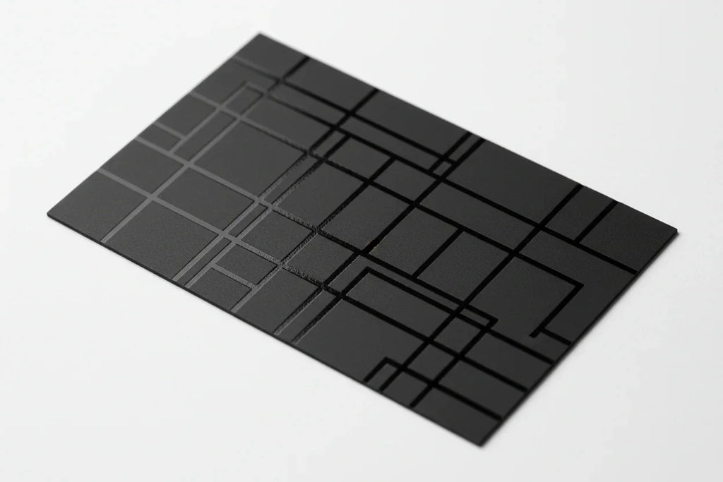 Black business card with geometric spot UV gloss design on white background