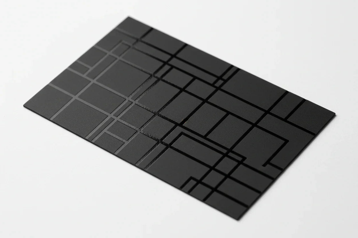 Black business card with geometric spot UV gloss design on white background
