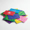 Colorful custom print gift cards with various icons piled on a white background