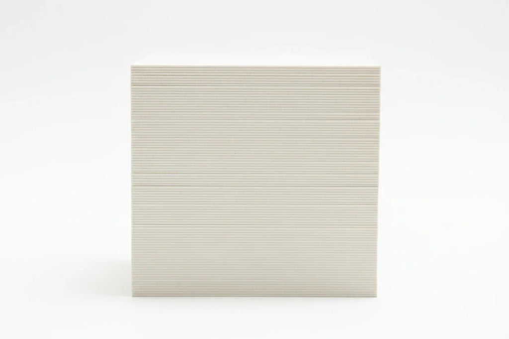 Stack of thick 19-point business cards viewed from the side on a white background