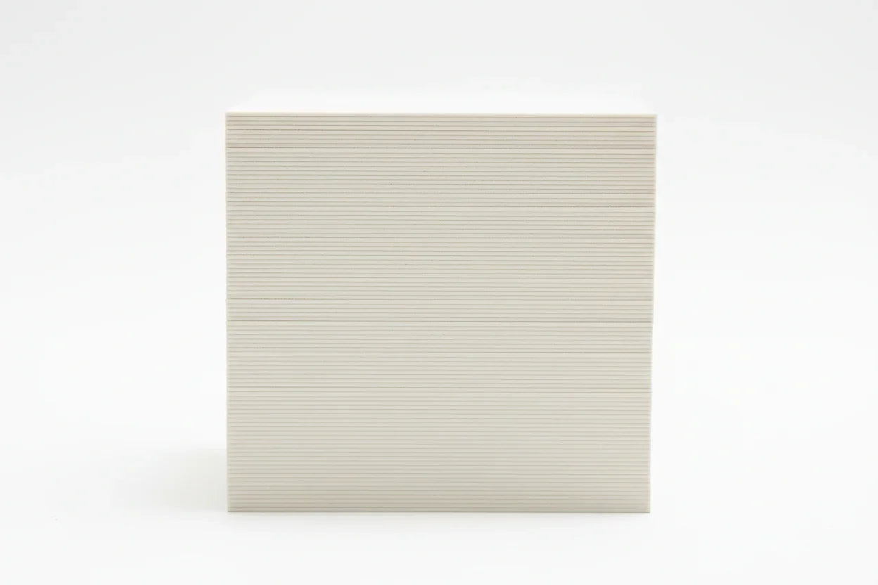Stack of thick 19-point business cards viewed from the side on a white background