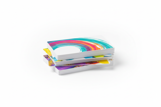 a stack of plastic business cards, white pvc with color printing on a white background