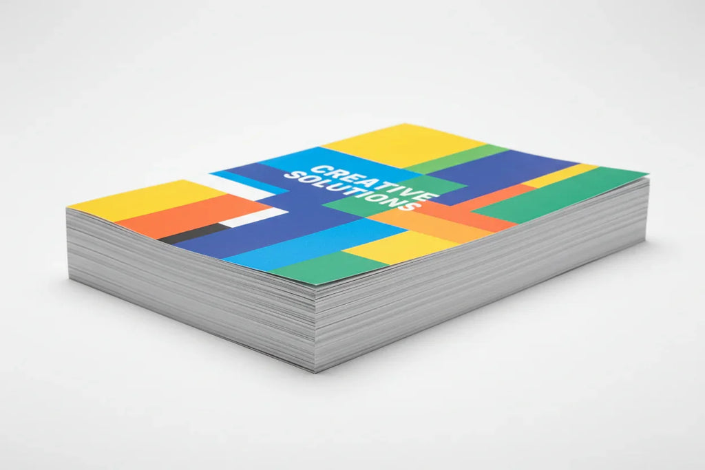 Stack of single-page color flyers with modern geometric design on white background