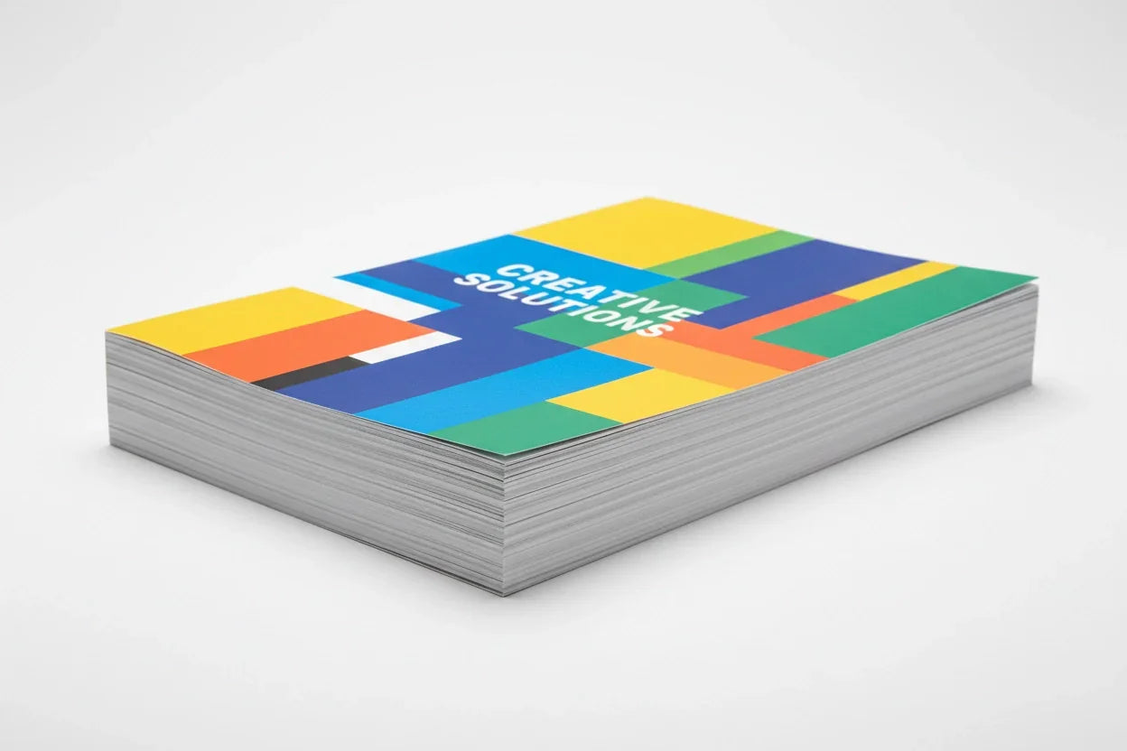 Stack of colorful single-page flyers with creative geometric design on white background
