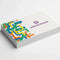 Stack of cotton business cards with colorful abstract printing on white background