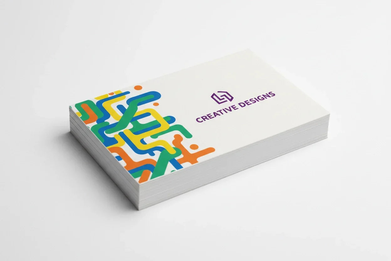 Stack of cotton business cards with colorful abstract printing on white background