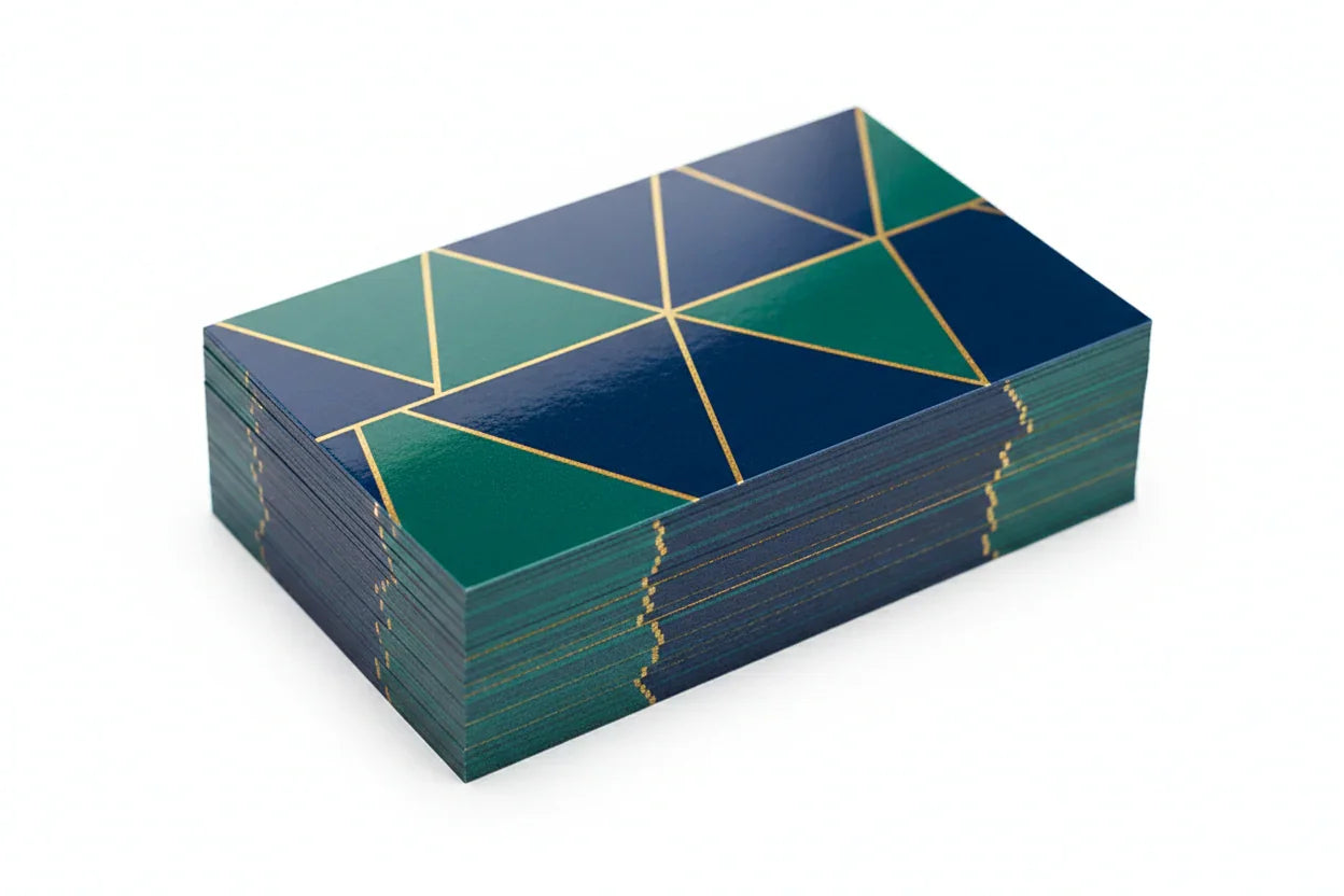 Stack of custom printed business cards with geometric design, glossy coating on white background