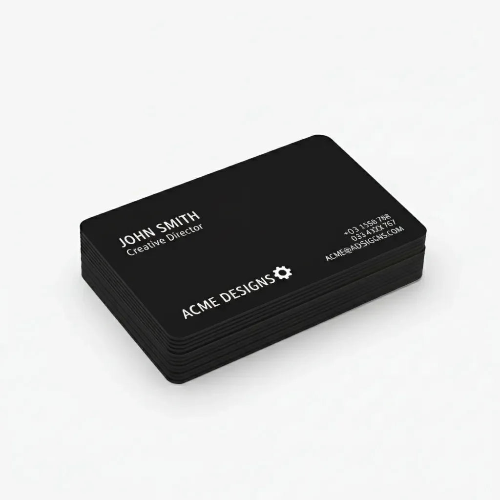Stack of custom black business cards with white text on clean background