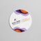 Color printed circular business card with purple and orange graphic accents on white background