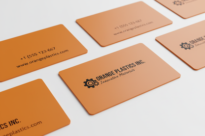 opaque orange plastic business cards with black printing on a white background