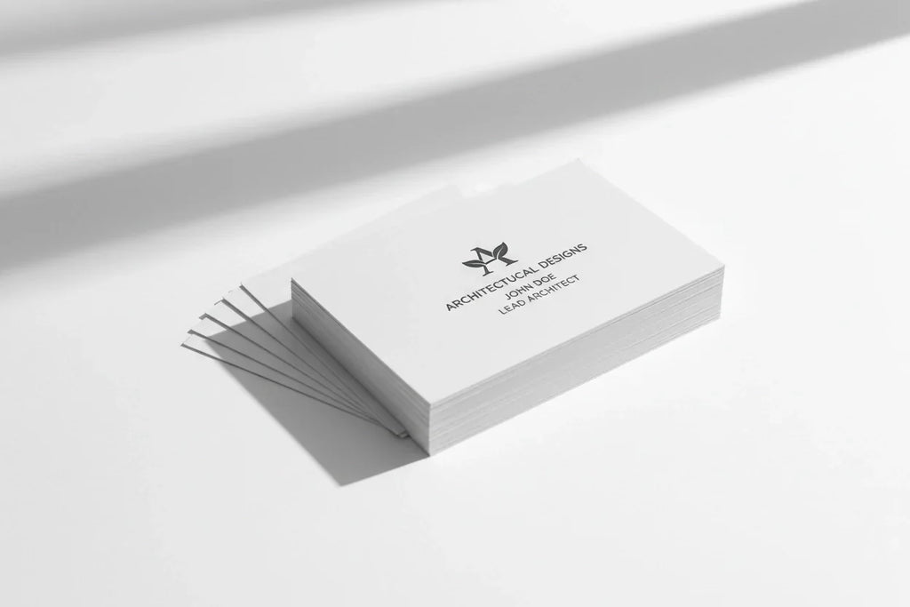 Stack of custom printed business cards on a white background with minimalist design