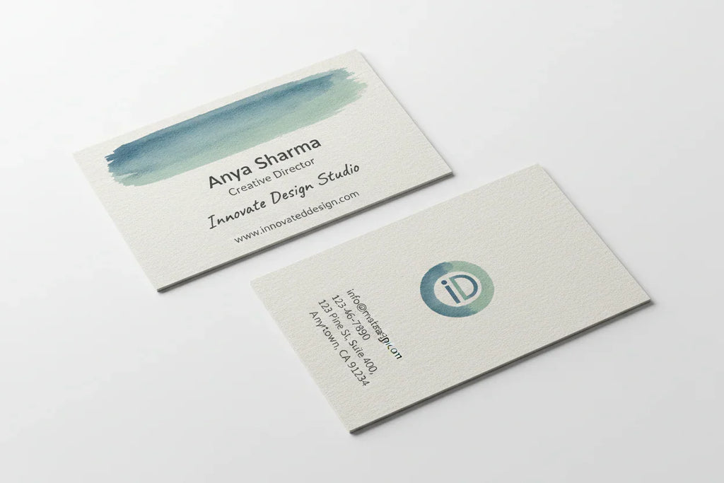 Two color-printed business cards on uncoated linen stock, front and back, on white background.