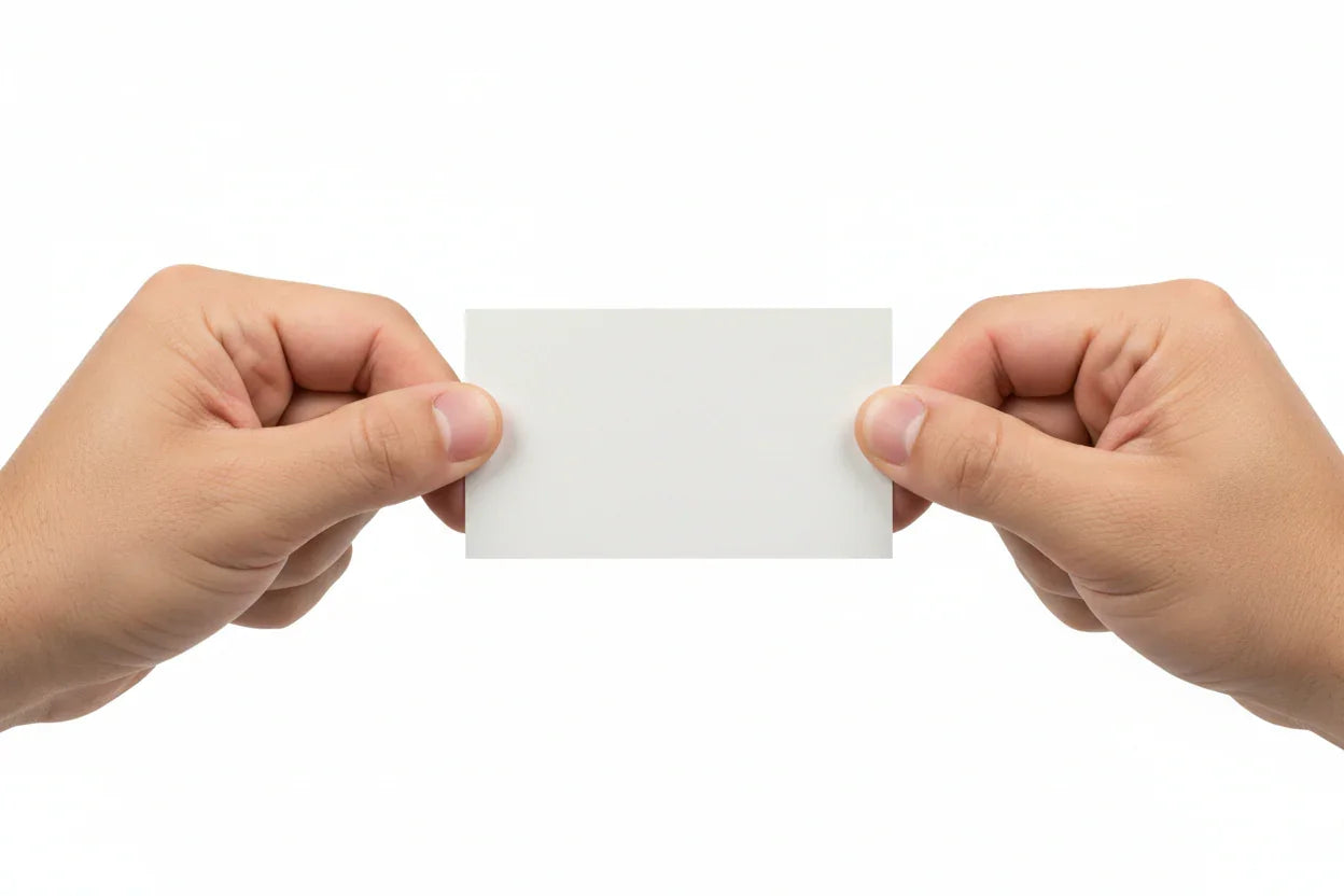 Two hands pulling a tearproof synthetic business card on a white background